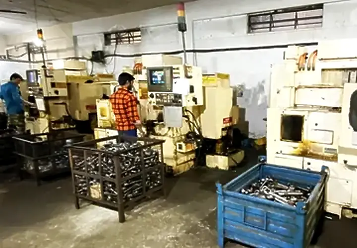 CNC turning cell with finished pins and bushes in crates