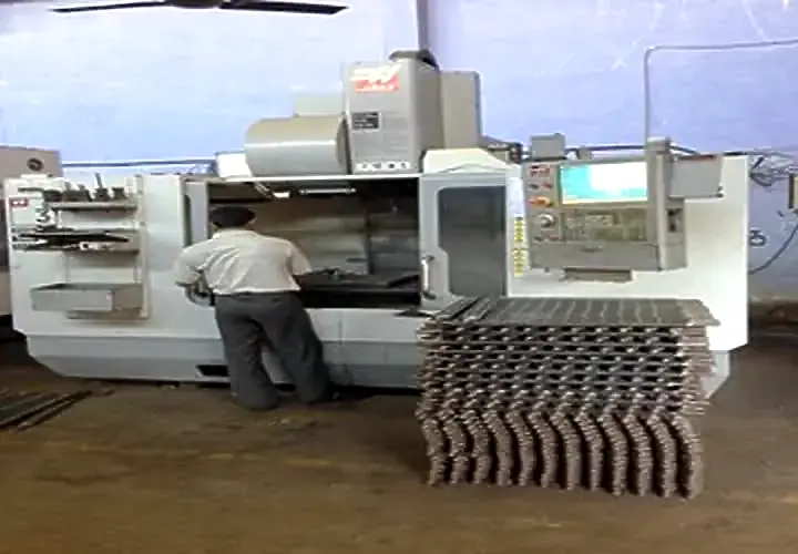 Vertical machining centre with fabricated implement parts