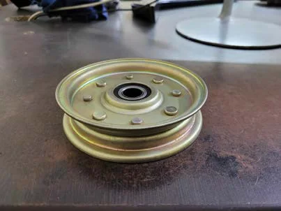 Flat idler pulley for mower decks, side view